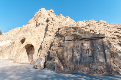 Low angle view of rock formation against clear blue sky