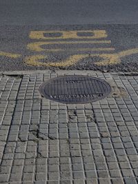 High angle view of manhole on street