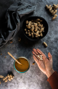 High angle view of hand holding food on table