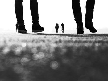 Low section of people walking on street