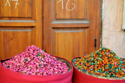 Close-up of pink flowering plants on wooden door