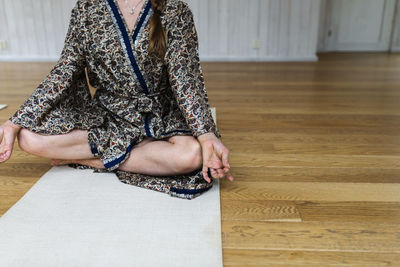 Low section of woman meditating