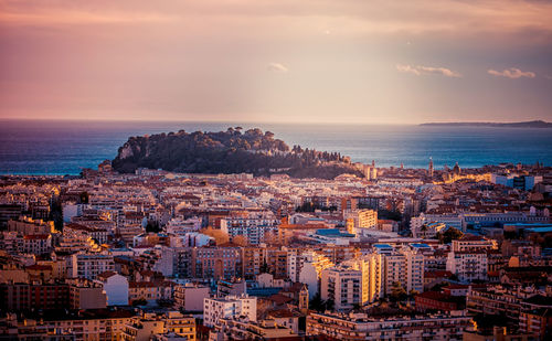 High angle view of townscape by sea against sky