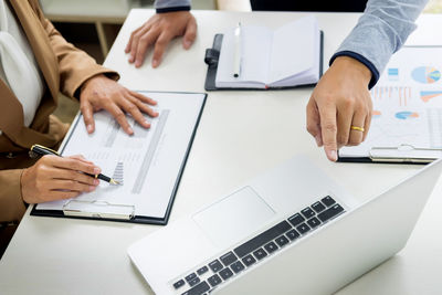 Low angle view of people working on table
