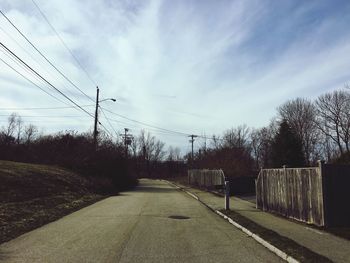 Railroad tracks amidst trees against sky