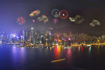 Firework display against sky at night