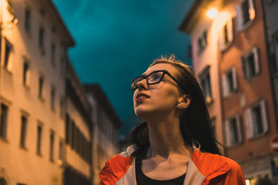 Low angle view of young woman in city