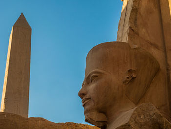 Low angle view of statue of liberty against sky