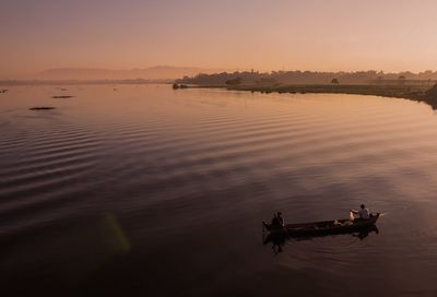 Scenic view of lake against clear sky during sunset