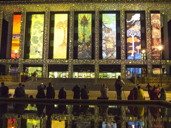 Group of people in illuminated building at night