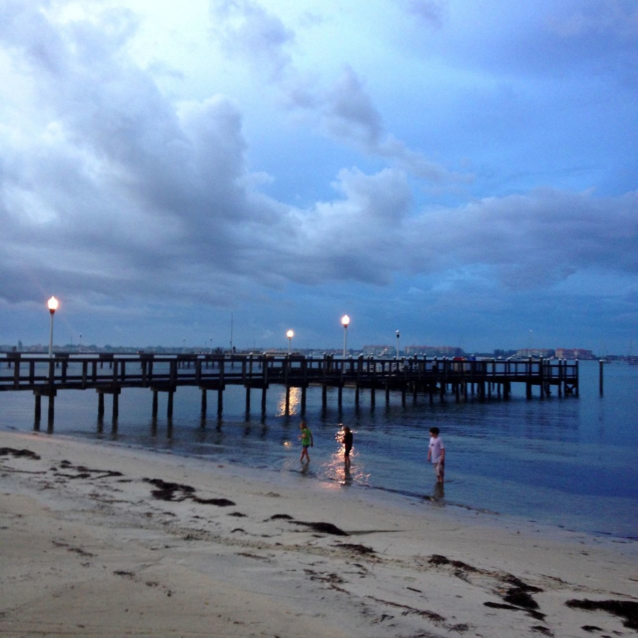 sea, beach, water, sky, cloud - sky, sand, horizon over water, shore, pier, tranquility, scenics, tranquil scene, beauty in nature, nature, cloudy, dusk, sunset, idyllic, cloud, incidental people