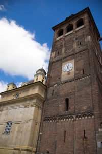 Low angle view of clock tower against sky