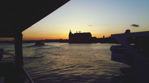 Boat in sea at sunset