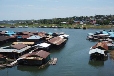 High angle view of houses by river against sky