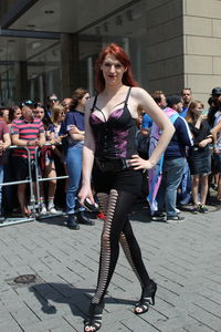 Full length portrait of young woman on street in city