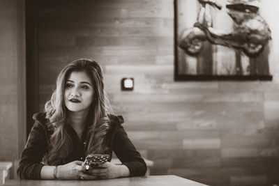 Young woman sitting on table