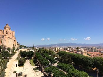 High angle view of city against blue sky