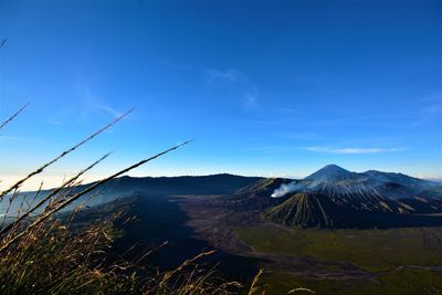 Scenic view of landscape against blue sky