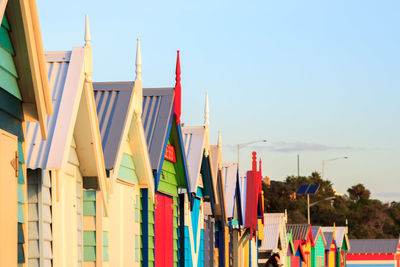 Close up of colourful brighton beach bathing boxes against clear sky