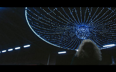 Low angle view of illuminated electric lights against sky
