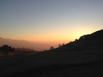 Scenic view of mountains against sky at sunset