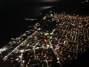 Aerial view of illuminated buildings in city at night