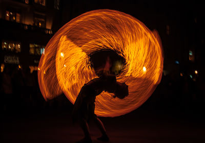 Side view of man dancing at night