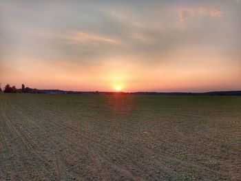 Scenic view of field against sky during sunset