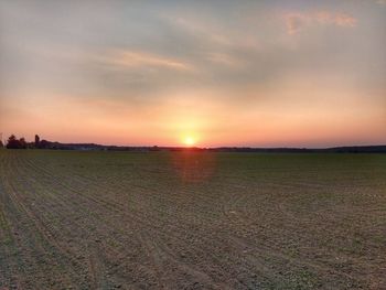 Scenic view of field against sky during sunset