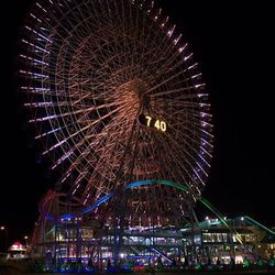 Low angle view of ferris wheel at night