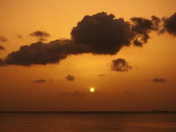 Scenic view of sea against orange sky