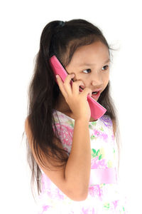 Portrait of cute girl against pink background