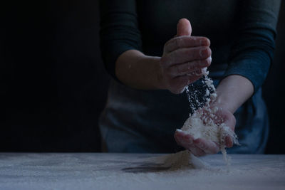 Woman baker with flour in her hands