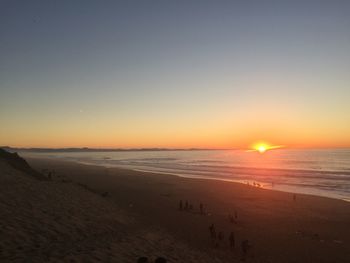 Scenic view of beach against sky during sunset