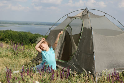 Cute girl setting up tent