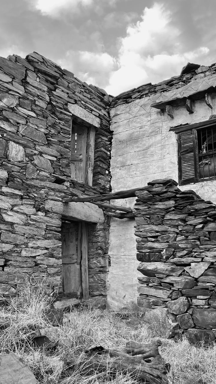 architecture, ruins, built structure, building exterior, building, cloud, black and white, sky, house, rock, monochrome, no people, nature, monochrome photography, white, wall, ancient history, history, old, abandoned, residential district, day, the past, outdoors, rural area, landscape, wood, damaged, shack, rundown, stone wall, rural scene, stone material, wall - building feature, land, window, weathered, old ruin
