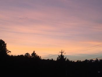 Silhouette trees against sky at sunset