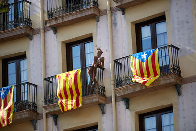 Low angle view of flags hanging on building