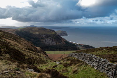 Scenic view of sea and mountains against sky