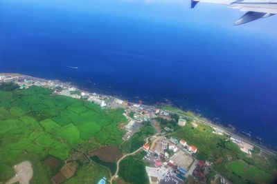 High angle view of airplane flying over sea