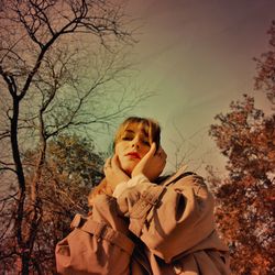 Portrait of happy girl on bare tree