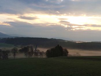 Scenic view of field against sky during sunset