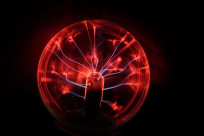 Close-up of red plasma ball against black background