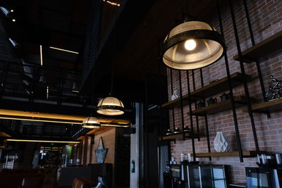 Low angle view of illuminated pendant lights hanging in building