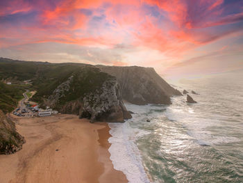 Scenic view of beach against sky during sunset