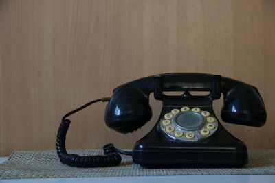 Close-up of telephone booth on table