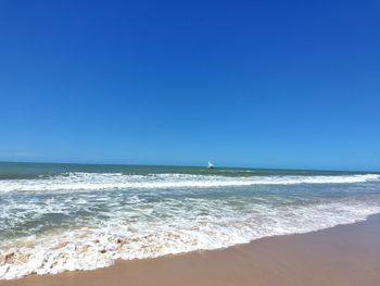 Scenic view of sea against clear blue sky