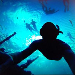 Woman swimming in aquarium