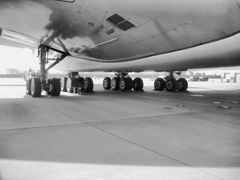 Airplane on airport runway against sky