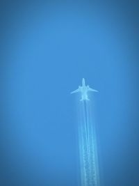 Low angle view of airplane flying in sky